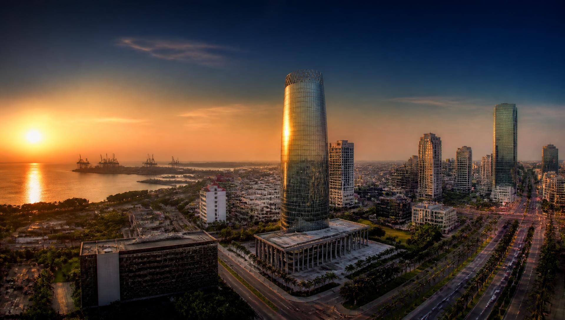 Aerial view of a West African coastal city skyline at golden hour